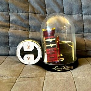 Louis Vuitton Ear Buds along with a globe